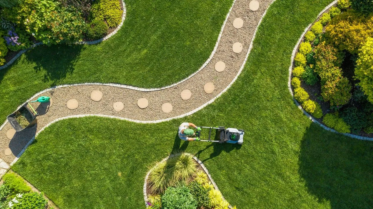 Aerial view of a landscaped villa garden with lawn, stone pathway and planting in Saudi Arabia